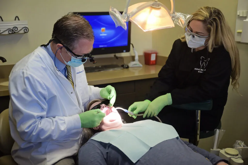 Dr. Warren putting a dental crown on a patient's tooth in Litchfield Park, AZ