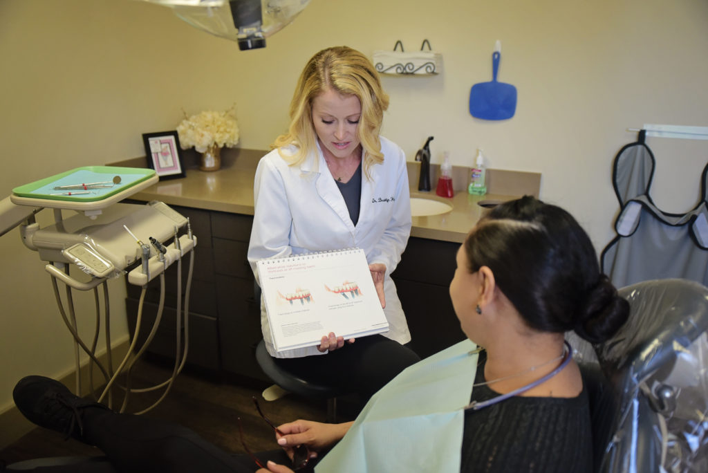 Dr. Hagerman showing a patient how dental implants work