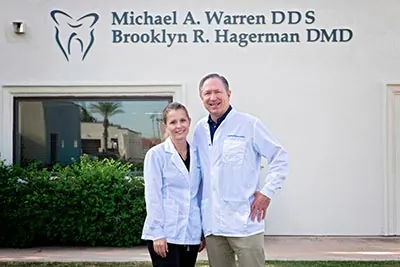 Brooklyn R. Hagerman DMD and Michael A. Warren DDS standing together in front of their dental office in Litchfield Park, AZ